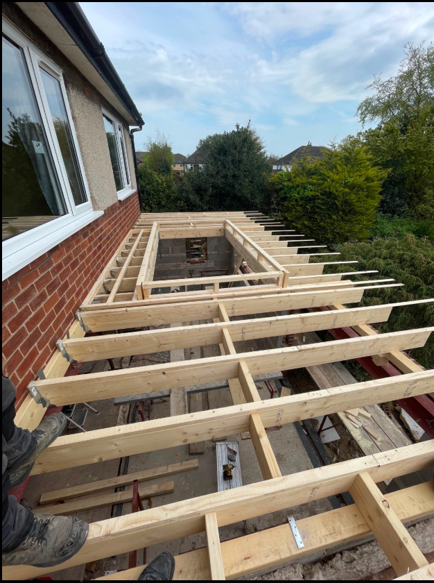 Timber flat-roof joists framing a rooflight opening