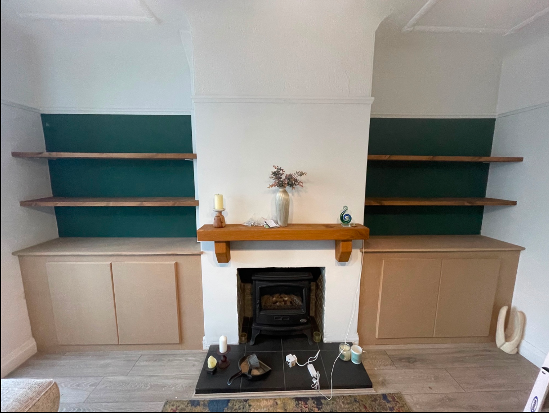 Made-to-measure alcove cabinets and timber shelves surrounding a fireplace