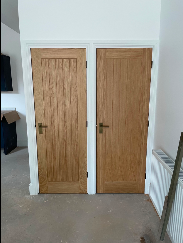 Pair of fitted solid oak internal doors with matching ironmongery