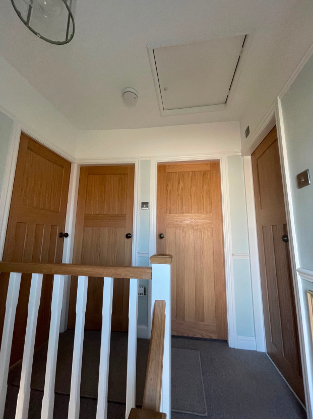 Oak internal doors hung around an upper landing and staircase