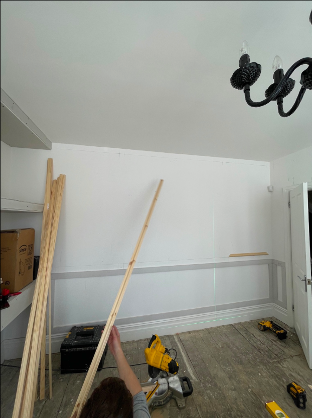 Interior wall being measured and set out for decorative timber mouldings